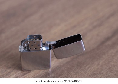 Silver Lighter On A Table.