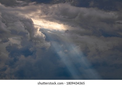 Silver Lining. Sun Rays Shine Through An Opening In The Storm Clouds.