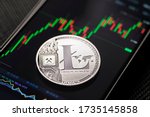 Silver litecoin cryptocurrency trading on smartphone close up