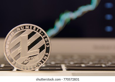 Silver Litecoin on keyboard with increasing chart