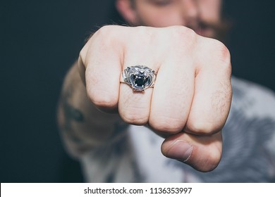 Silver Male Ring In The Form Of A Tiger With A Stone In The Fangs. On The Fist At The Mustached Man. Macro.