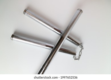 A Silver Metal Nun Chuck And A Silver Metal Stick