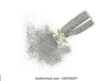 silver metal powder in a glass vial on a white background