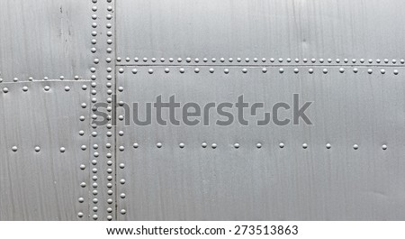 Silver metal texture with rivets. Abstract weathered metallic background. 
