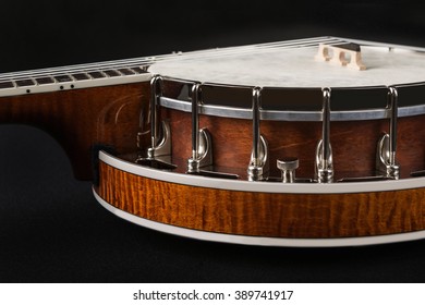 Silver metalic Banjo with wooden back isolated on black background