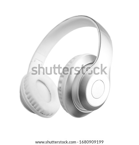 Silver metallic white wireless headphones in the air isolated on white background. Trendy minimal music device flying levitation concept of accessories. New technologies. Closeup high resolution