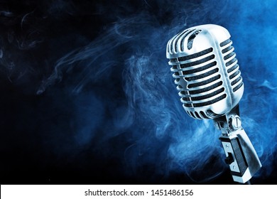 Silver microphone closeup on blue smoke background