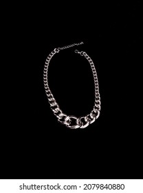 Silver Necklace Chain On A Black Background