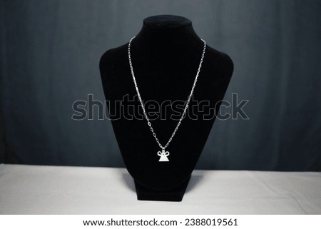 Silver necklace with Phiaj or soul lock pendant on black mannequin