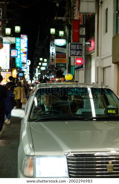 silver old taxi driving around tokyo japan at night\
, november japan 2019