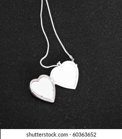Silver opened heart on black background, jewelery