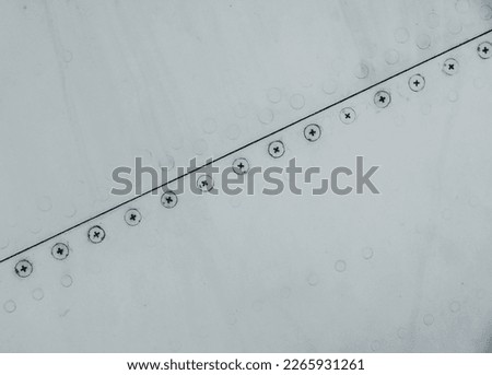 Silver painted metal surface with rivets used for aircraft engineering and machinery industry