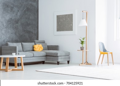 Silver Painting Above Grey Couch Set With Yellow Pillow In Spacious Living Room With Contrast Walls