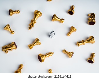 A silver pawn chess piece standing alone in the middle of many fallen silver pawn chess pieces on white background. Stand out from the crowd. Leadership, Unique, survivor, winner, difference concept. - Shutterstock ID 2156164411