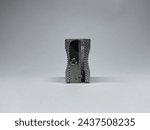 The silver pencil sharpener has a little dirt, placed vertically on a white background, front view