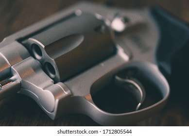 Silver Revolver Gun And Wooden Background