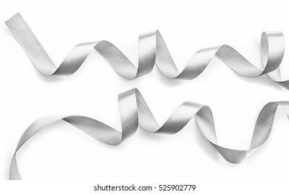 Silver ribbon bow in bright silver white grey color isolated on white background with clipping path for holiday and party greeting card design decoration element
