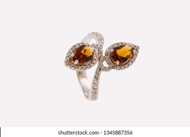 Silver ring with amber gemstones.  Women jewelry with drop shaped precious stones. Isolated on a clean background.