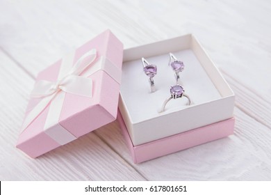 Silver Ring And Earrings With Amethyst In The Gift Box On Wooden Background