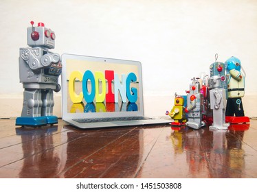 silver robot teaching about code  to kid robot toys