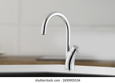 Silver Round Shiny New Faucet. Metal Crane In The Close-up Photo. Silver Crane As Kitchen Equipment.Macro Photo With High Quality.Photo Of Faucet In Minimalistic Style.Metallic Faucet For A Household.