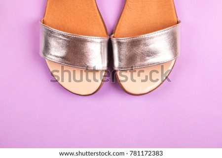 Silver sandals on purple background. Fashion concept. Place for text.