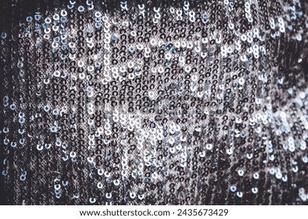 Silver sequin fabric, full frame. Festive fabric background. Close-up.