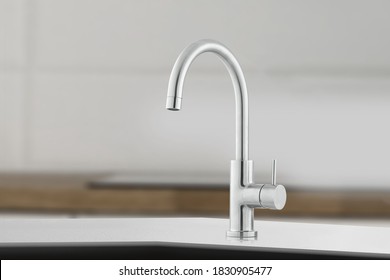 Silver Shiny Faucet At The Kitchen. Metal Crane In Close-up Photo. Modern Furniture.Silver Crane As Kitchen Equipment. Macro Photo With High Quality. Photo Of Faucet In Minimalistic Style.
