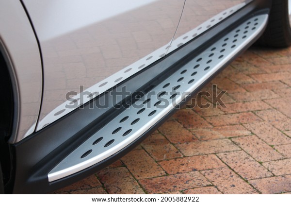 Silver side step of a luxury\
SUV