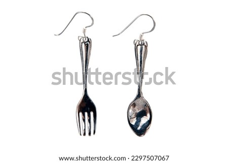 Silver spoon and fork earrings isolated on white background.