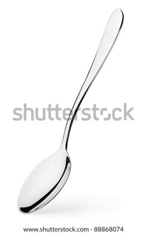 Silver spoon stands vertically with shadow isolated on white