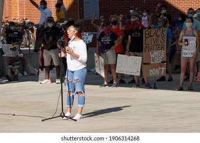 Silver Spring, Maryland  USA - June 08, 2020: Black Lives Matter (BLM) protest on Veteran Plaza. UMD students organize protest against racism. A young laddie speaks at the microphone.