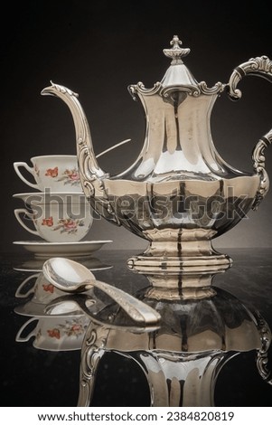 Silver tea set, teacups and silver spoons