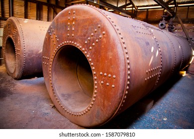 Silver Thorne and Adair Boilers. Large industrial condensing boilers. Rusty steel cylinders used in processing mine ore.