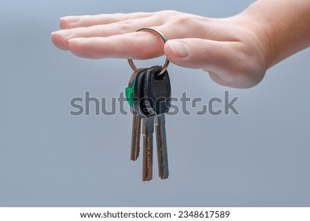 silver three house keys held in hand
