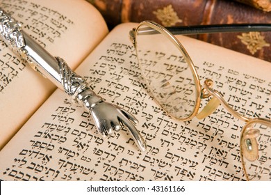 Silver Torah Pointer Lying On A Jewish Prayer Book