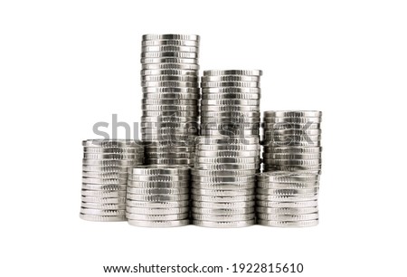 Silver towers made out of coins isolated on white