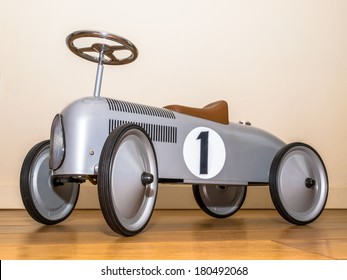 Silver Toy Push Car Against White Wall