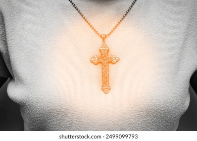 Silver vintage crucifix pendant or cross sign and chain necklace and close-up orange sweater. Easter festival. Faith. Christian. Jesus. Black and white tone   - Powered by Shutterstock