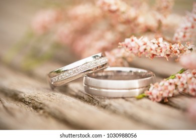 Silver wedding rings on a wooden  background