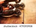Silver western riding spurs used on traditional American cowboy boots, on old barn or ranch style wood. 