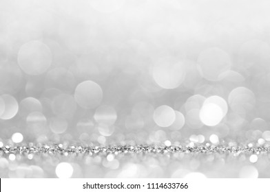 Silver white abstract light grey background, shining lights, sparkling glittering Christmas lights. Blurred abstract holiday background. - Shutterstock ID 1114633766