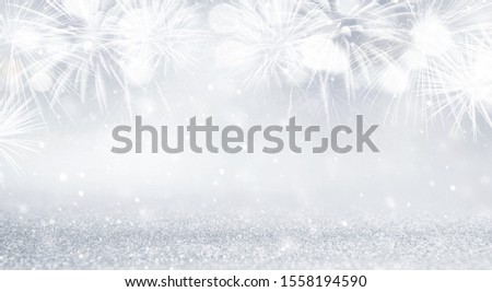 Silver and white Fireworks and bokeh in New Year eve and copy space. Abstract background holiday.