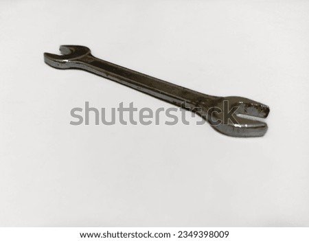 A silver wrench on a white background.