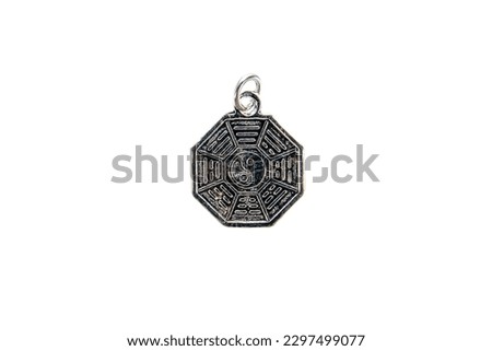 Silver Yin and Yang pendant isolated on white background.
