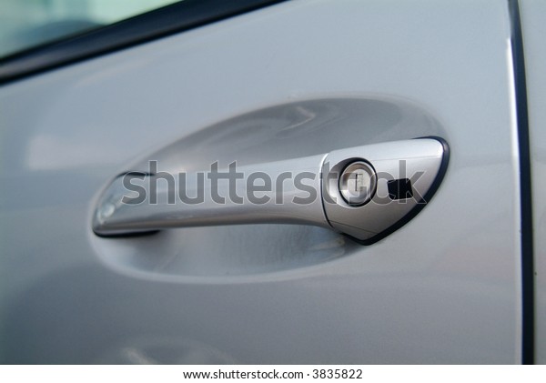 a silver-colored door\
pull from a car