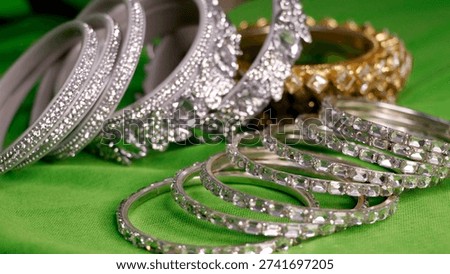silver-plated bangle bracelets, often studded with American Diamonds or cubic zirconia, similar to those offered by brands like Rubans or NVR..JPG