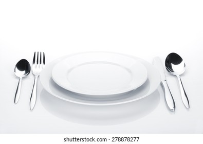 Silverware Or Flatware Set And Plates. Isolated On White Background