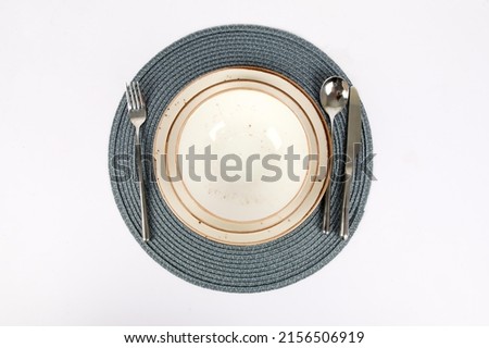 silverware or flatware set and plates isolated on white background.Part of a stylish table decoration with a plate and a knife.