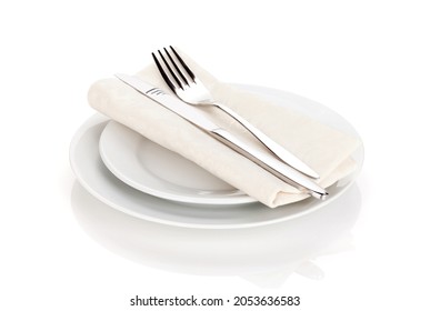 Silverware over plates. Isolated on white background. Set of fork, knife and spoons on empty plate - Powered by Shutterstock